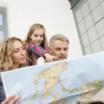 Family reviewing a map together while planning a holiday